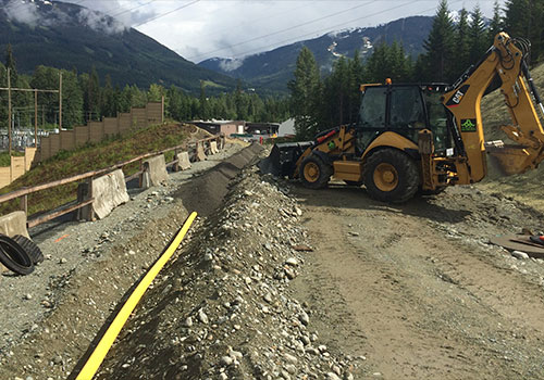 backhoe preparing gas trenches